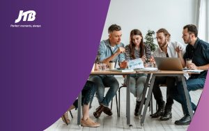 An image showing four people discussing with each other to compete smarter for group sales
